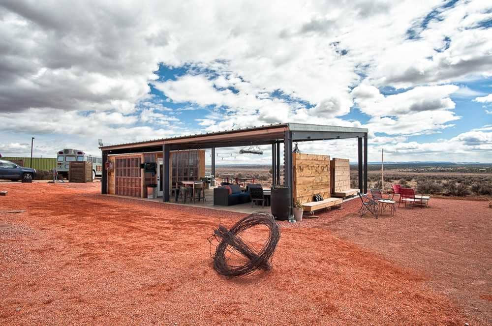 In the middle of the desert, a metal building provides shelter to visitors at a campground.
