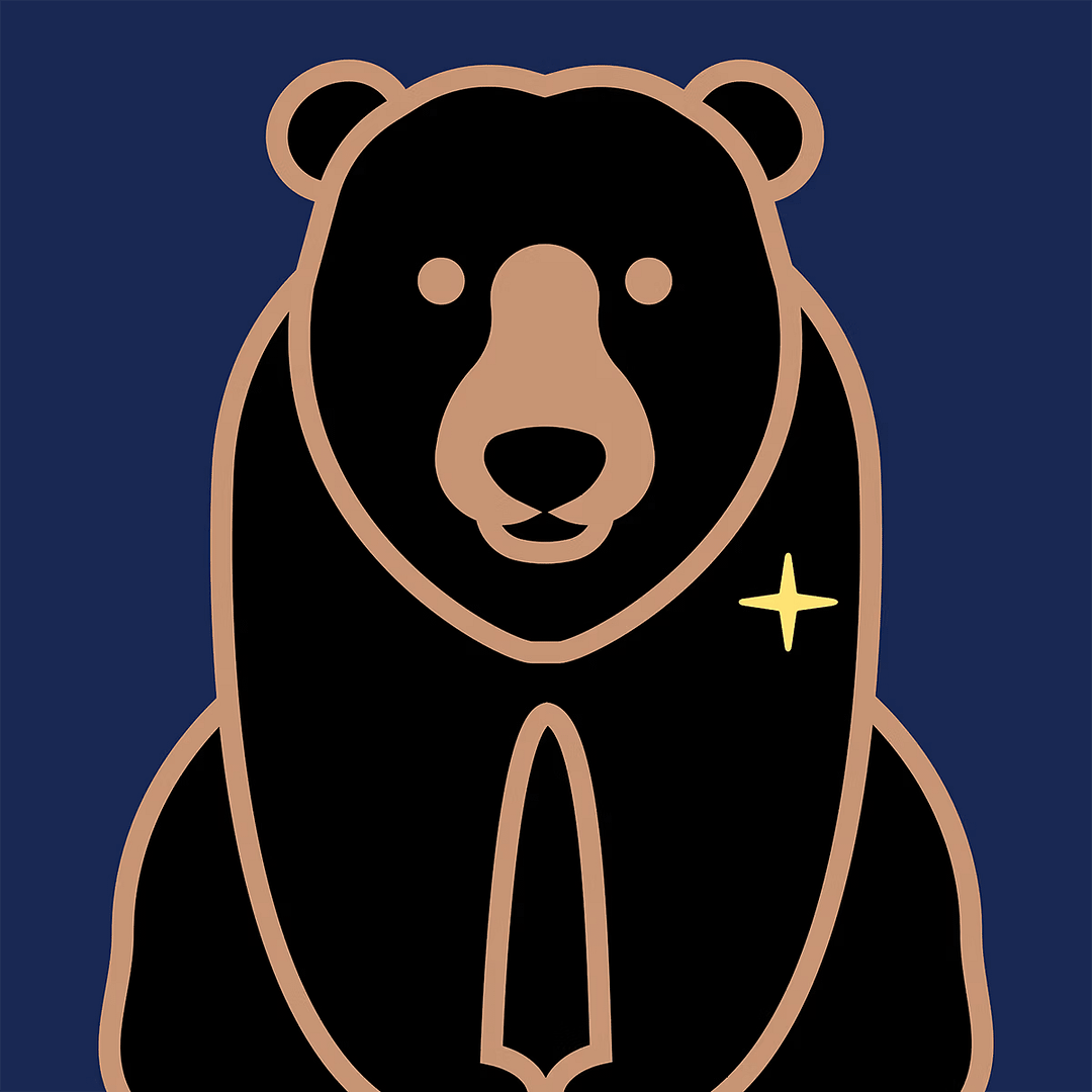 A black bear with a gold star on its fur in a bear den.