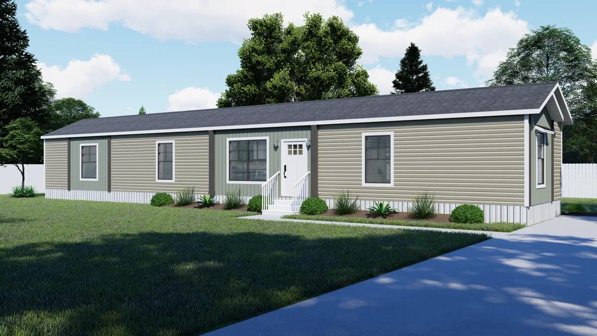 A single-story manufactured home with beige siding, white trim, and small front steps, surrounded by grass, shrubs, and trees under a partly cloudy sky.