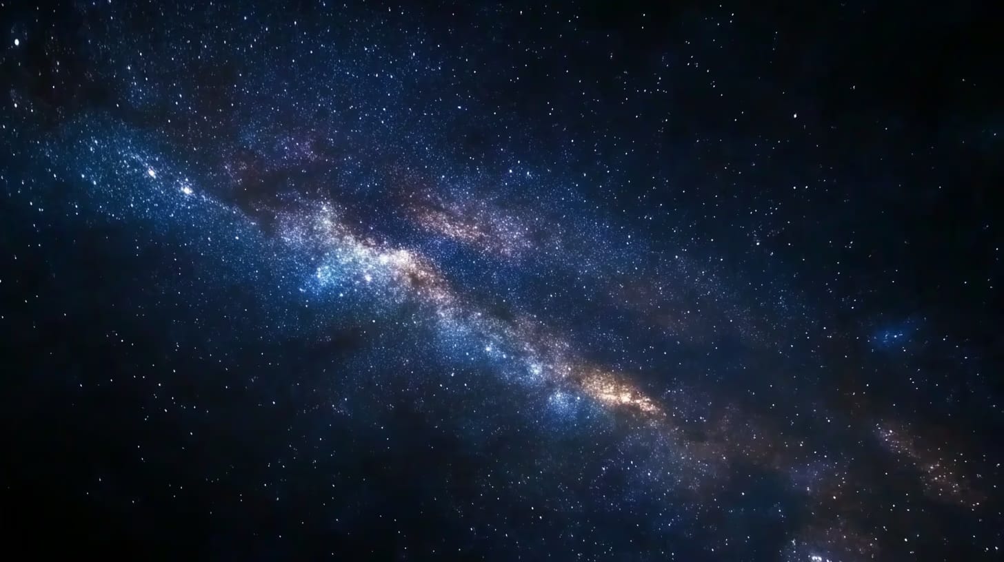 A breathtaking view of the Milky Way galaxy, showcasing a dense cluster of stars and cosmic dust bands stretching diagonally across the night sky. The image highlights shades of blue and purple, creating a vibrant celestial scene.