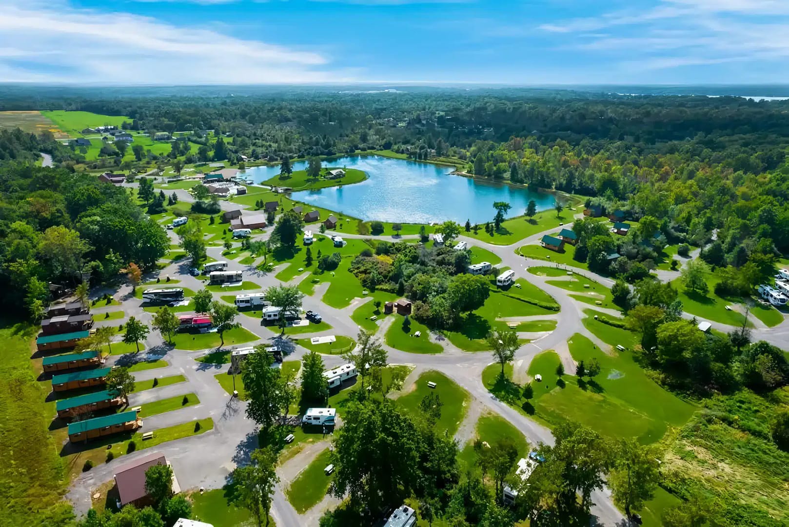 An aerial view of an rv park with a lake in the path of totality.