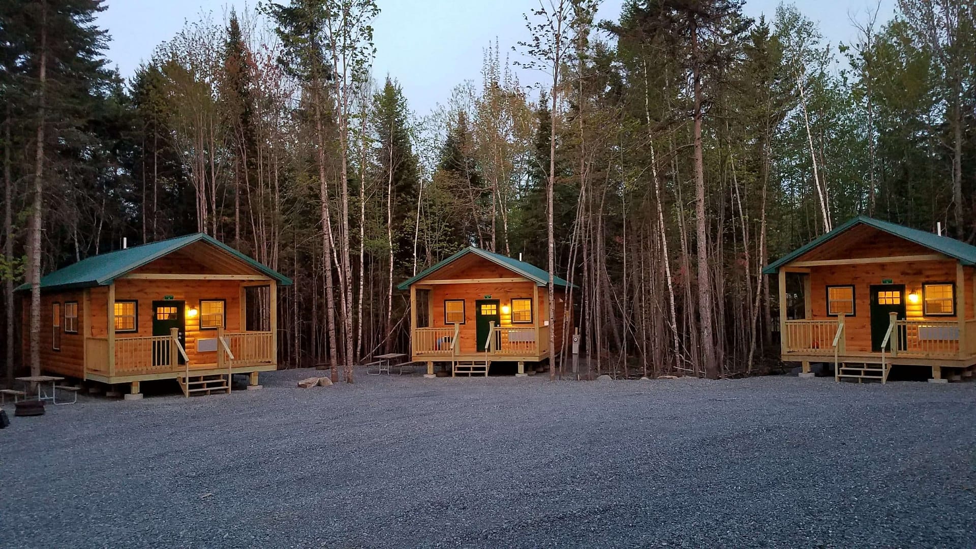 A two wooden cabins in the woods.