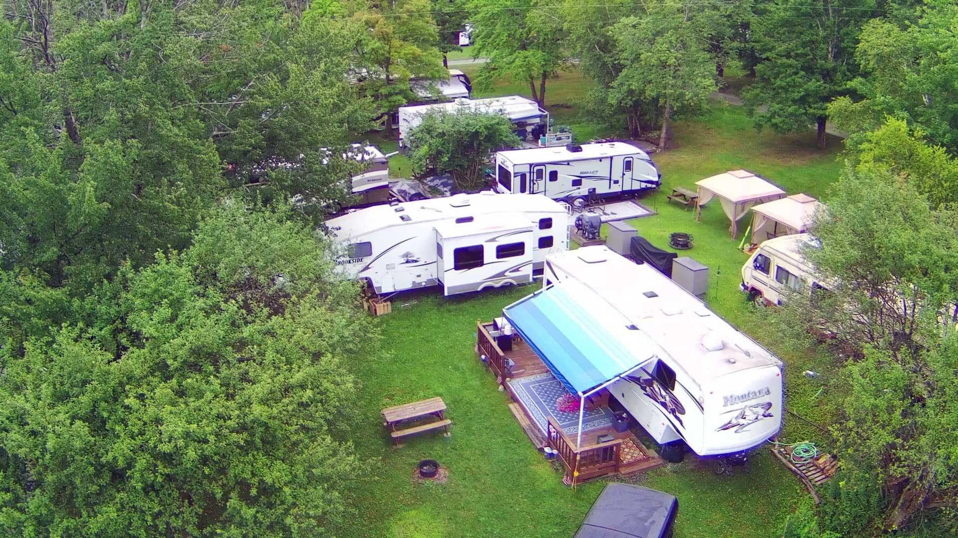 An aerial view of several RVs parked in a wooded area in Woodland Hills, California.