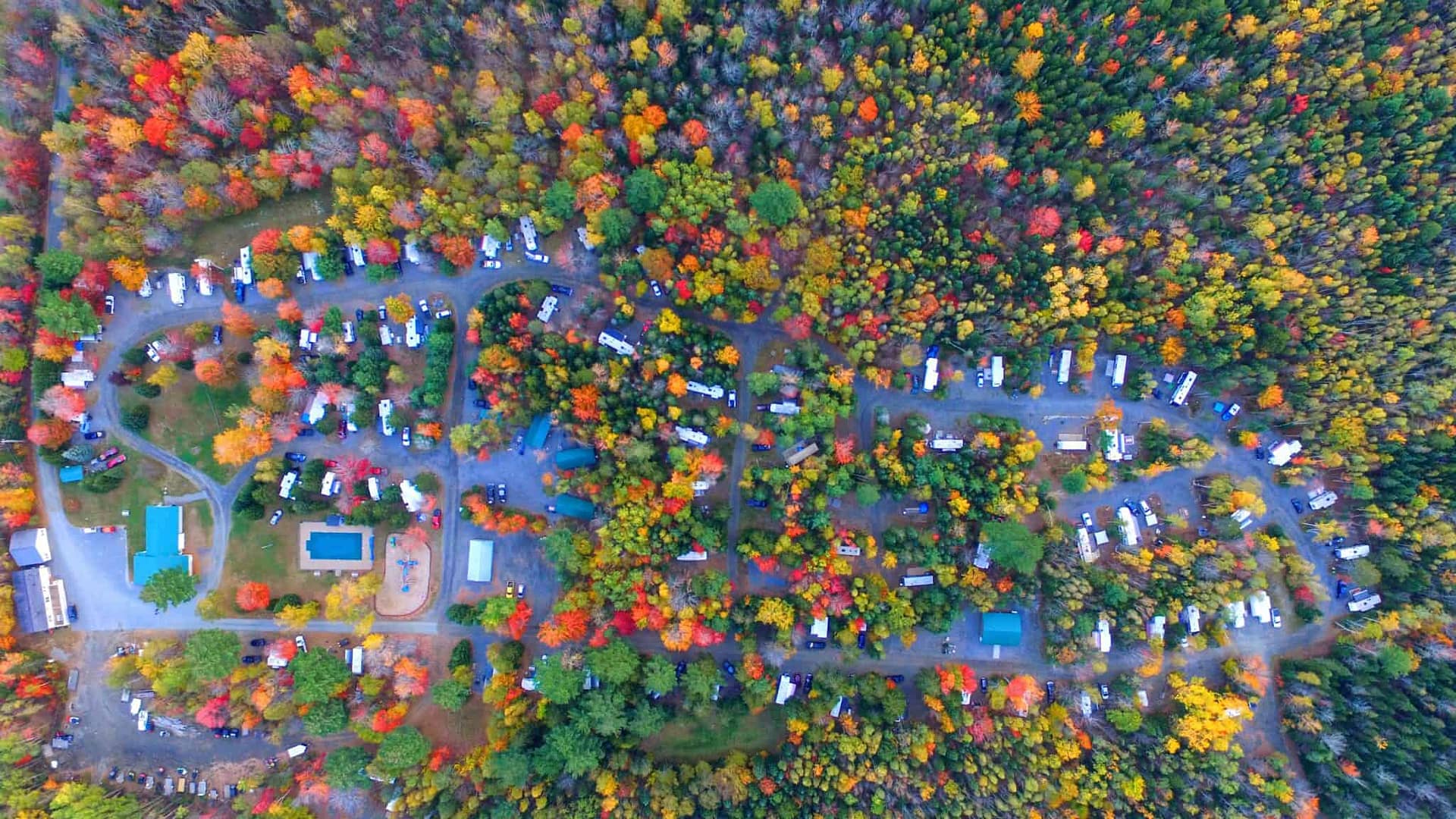 An aerial view of an rv park in the spring, showcasing blooming flowers.