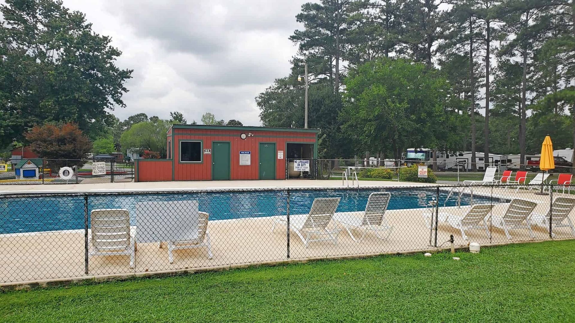 An RV park with a swimming pool and blooming flowers, perfect for enjoying Spring relaxation.