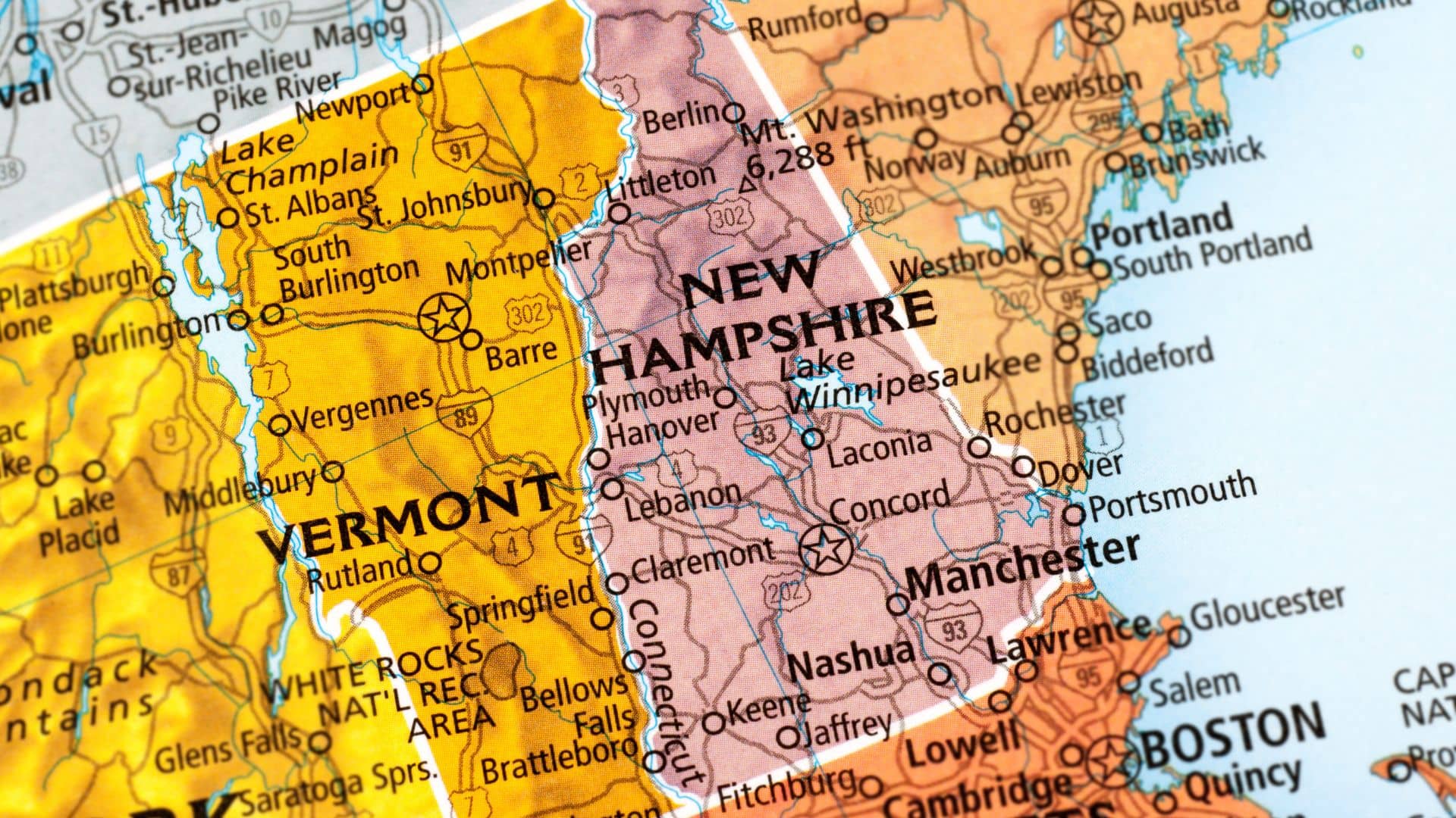 A detailed map highlighting parts of Vermont and Southern New Hampshire, capturing the essence of a road trip. Key cities like Montpelier, Concord, Nashua, and Manchester are labeled with roads and film-inspired geographic features such as lakes and rivers visible.