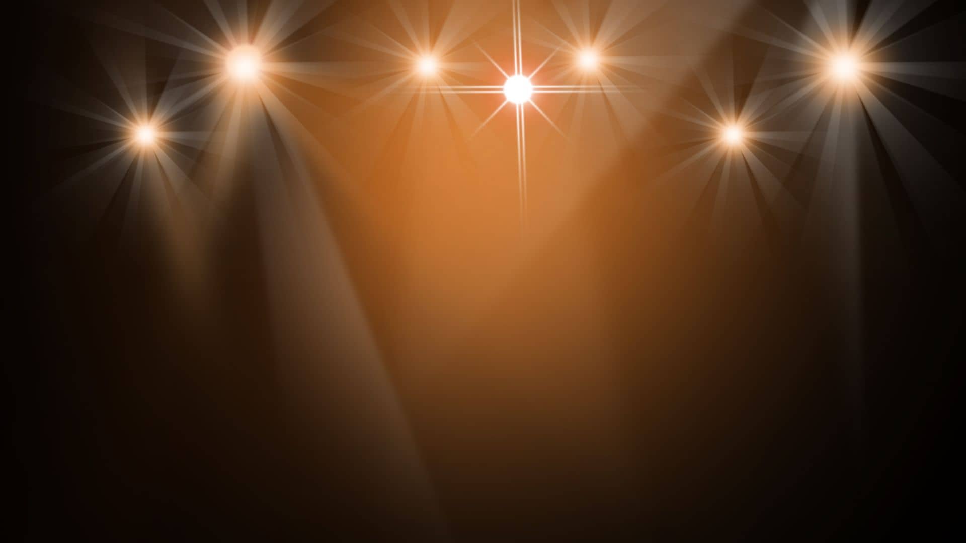 A series of bright, glowing spotlights shining down in a dark space, creating a warm orange glow and starburst effect, reminiscent of the enchanting illuminations at the Chautauqua Festival, with rays extending outward from the lights.