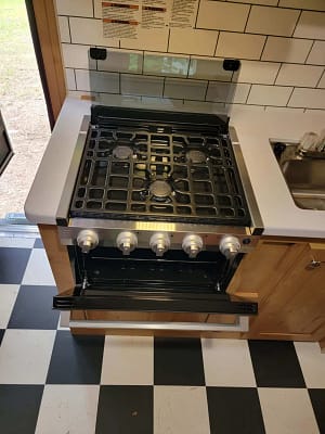 A black and white checkered kitchen with a stove top.