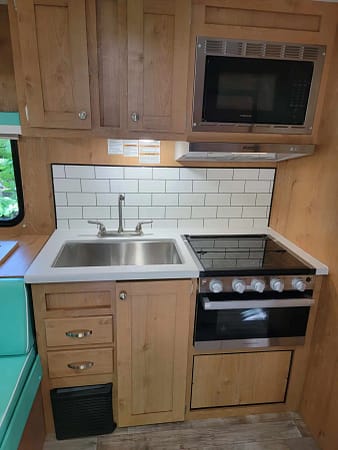 A kitchen with a microwave oven and stove.