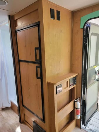 A wood door and shelf in a trailer.