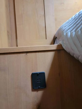 A black outlet on a wood surface.