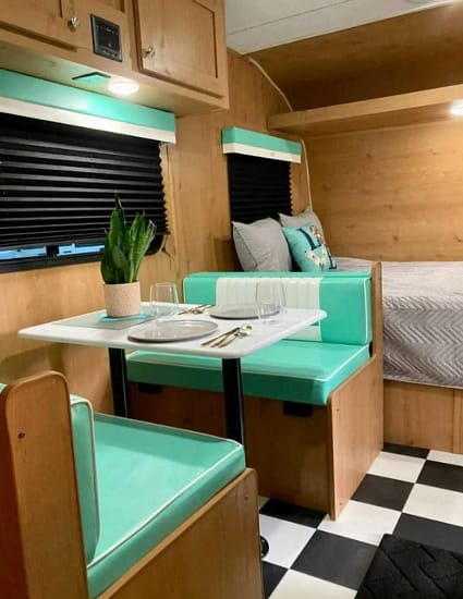 The interior of an Airstream RV with a checkered floor is perfect for those who enjoy camping.