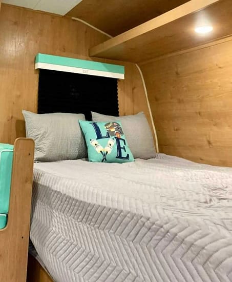 A small bedroom with a bed, suitable for camping or an RV.