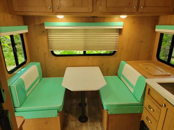 A table and chairs in a camper.