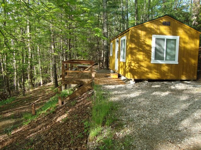 A yellow house in the woods.