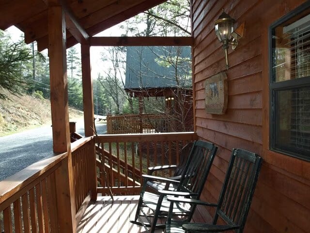 Rocking chairs on the porch of a cabin.