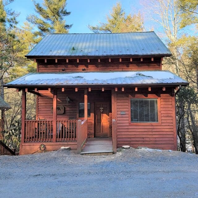 A wooden house with a porch and a porch.