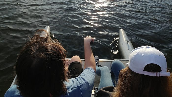 A group of people sitting on a boat.