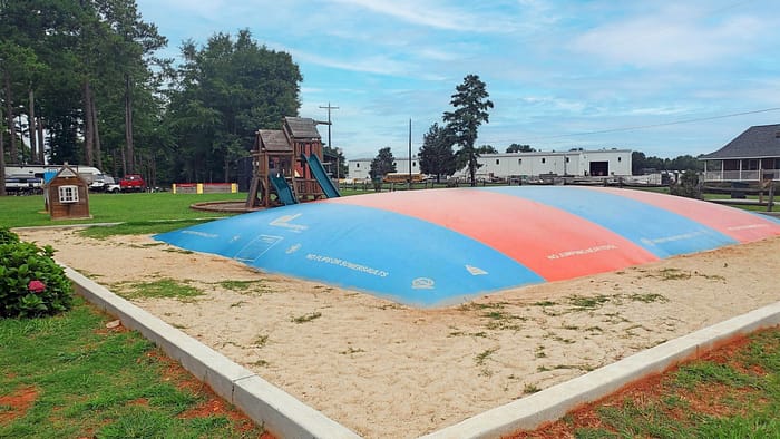 A playground with a large blue and red dome.