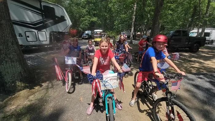 Children riding bicycles around Spacious Skies Campgrounds