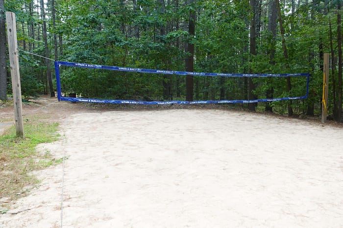 A blue tape on a sand court.