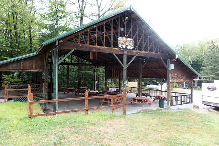 A wooden structure with tables and benches.