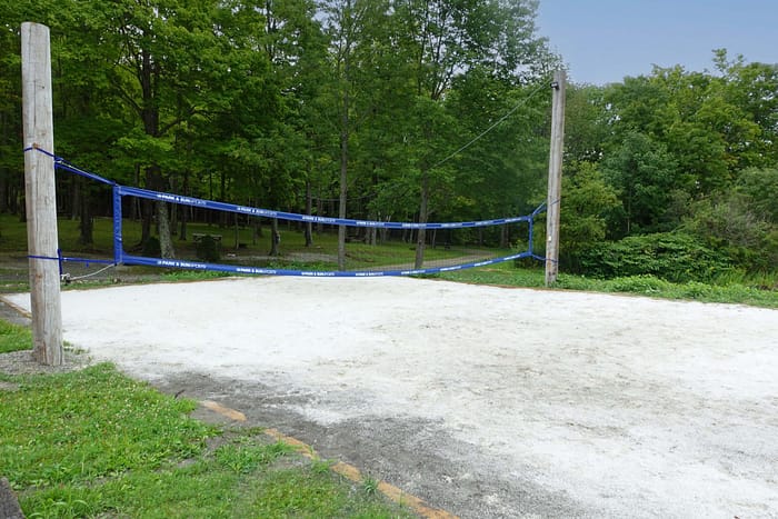 A volleyball court with blue tape.