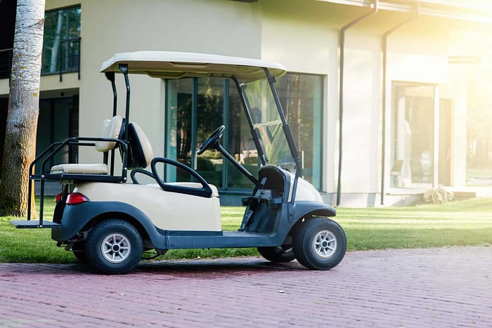 A golf cart parked in front of a building.