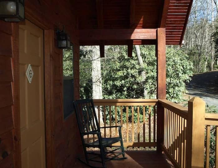 A rocking chair on a porch.