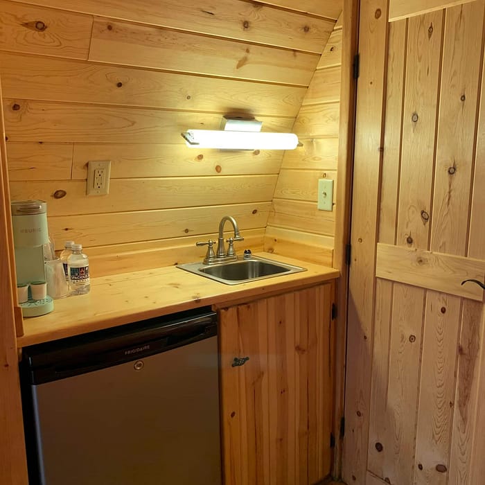 A small kitchen with a sink and a refrigerator.