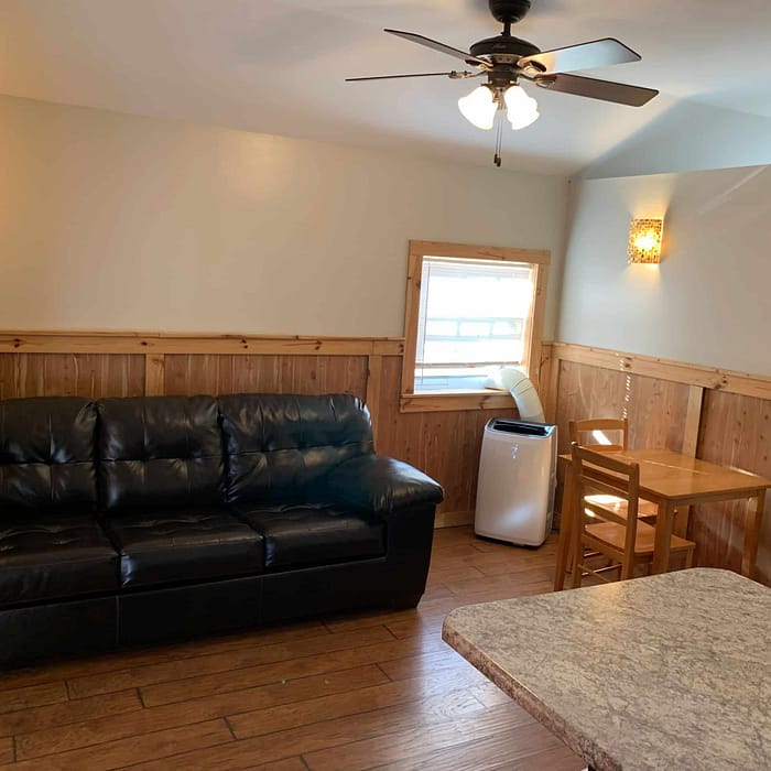 A living room with a couch and a table.