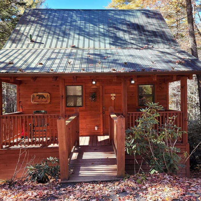 A wooden cabin with a porch and a porch.