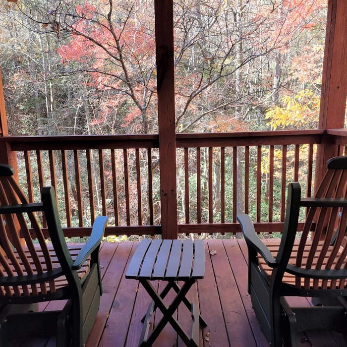 A deck with chairs and a table.