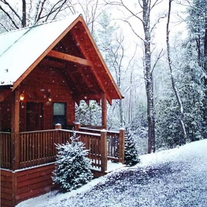 A cabin in the woods with snow.