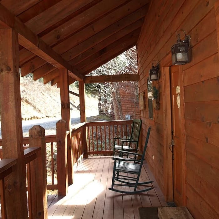 A porch with rocking chairs on it.
