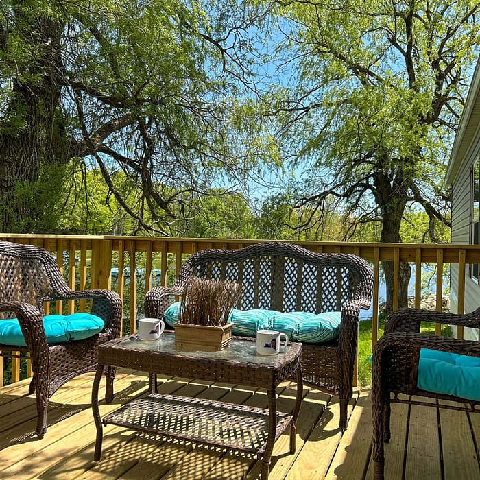 A deck with chairs and a table.