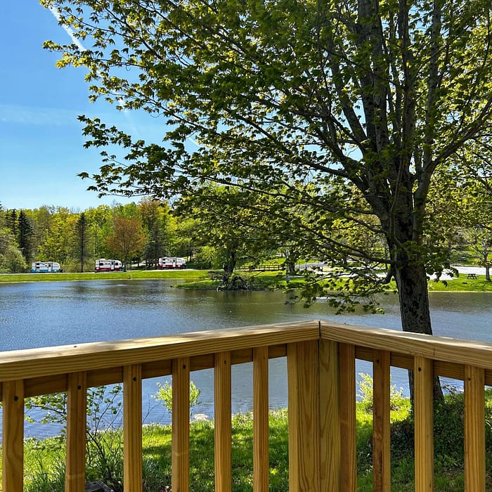 A wooden deck overlooking a lake.