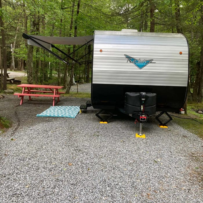 A trailer in the woods.