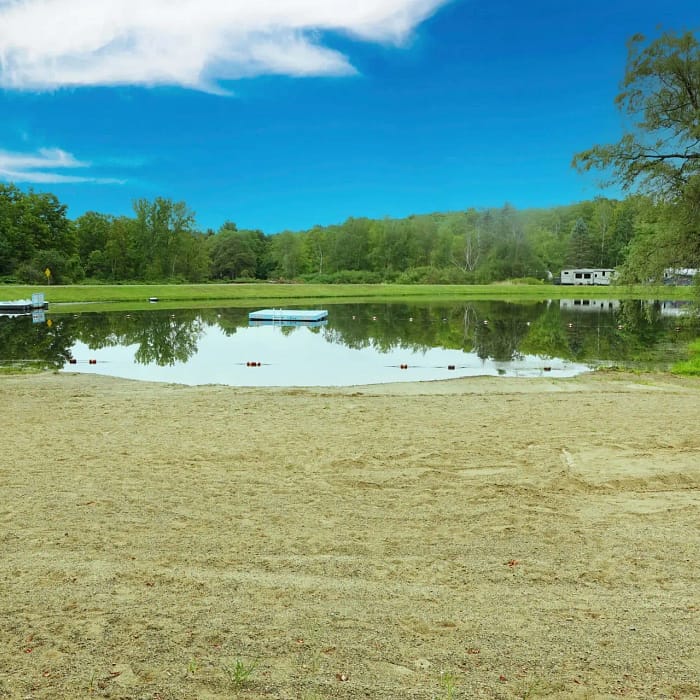 A sandy beach by a lake in Woodland Hills.