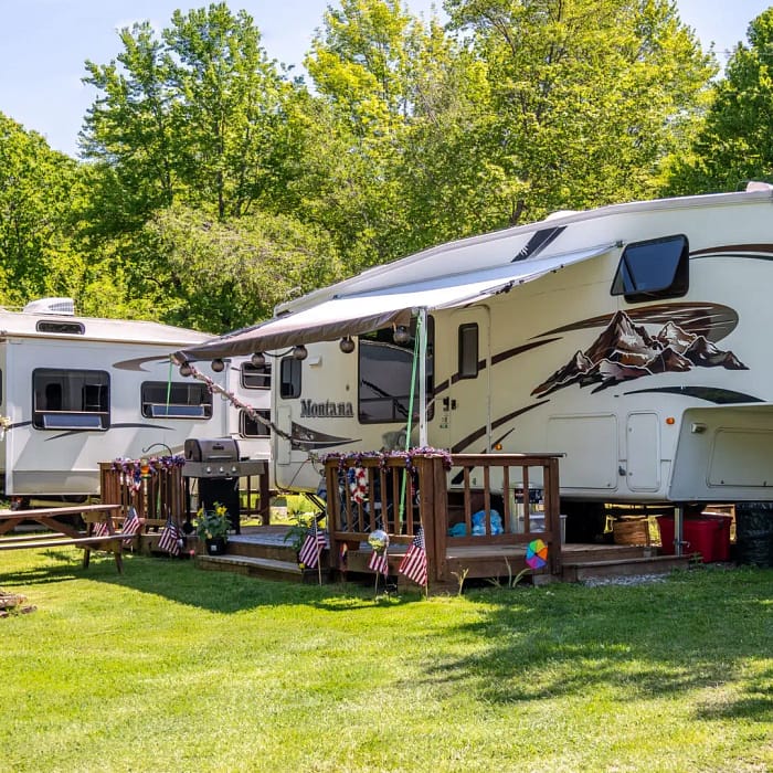 RVs parked at SPACIOUS SKIES WOODLAND HILLS AUSTERLITZ, NEW YORK