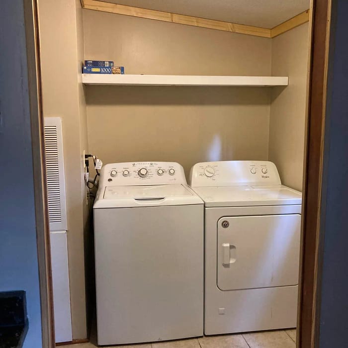 Laundry area with a washing machine and dryer inside a residential home.