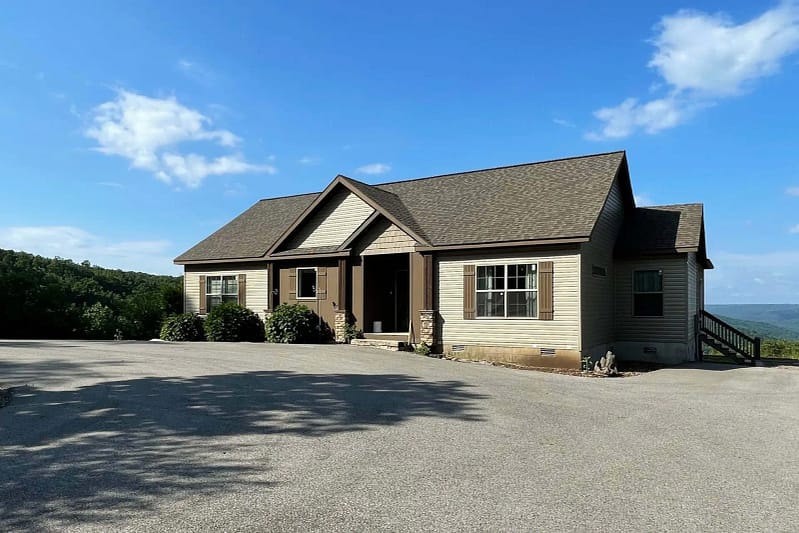 A Belle Ridge home with a driveway and a view of the mountains.