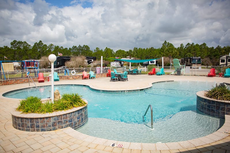 Family‑friendly pool and splash pad at Sugar Sands RV Resort.