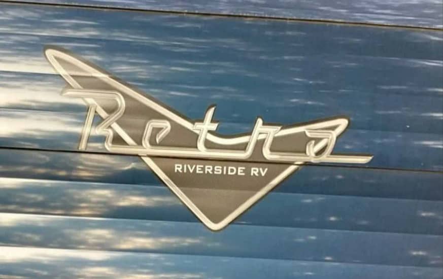 Retro riverside RV logo on the side of a camper.