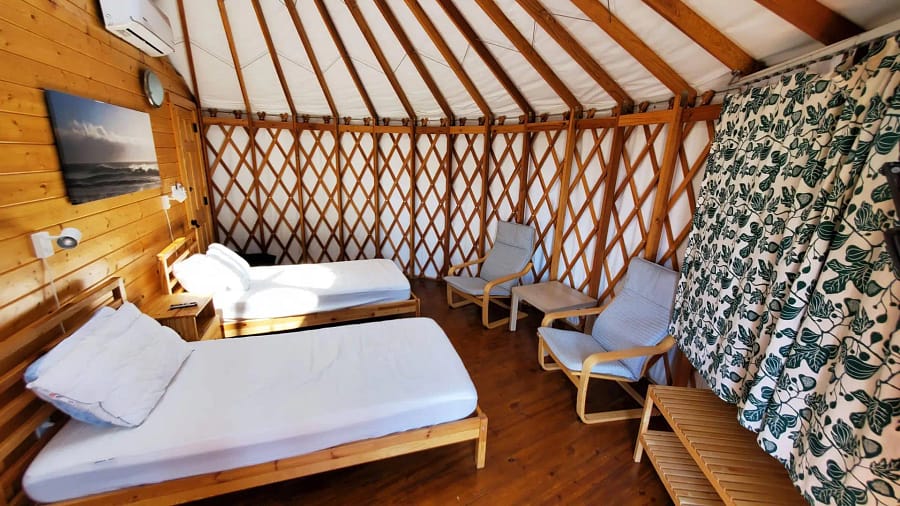 A room with two beds and a table.