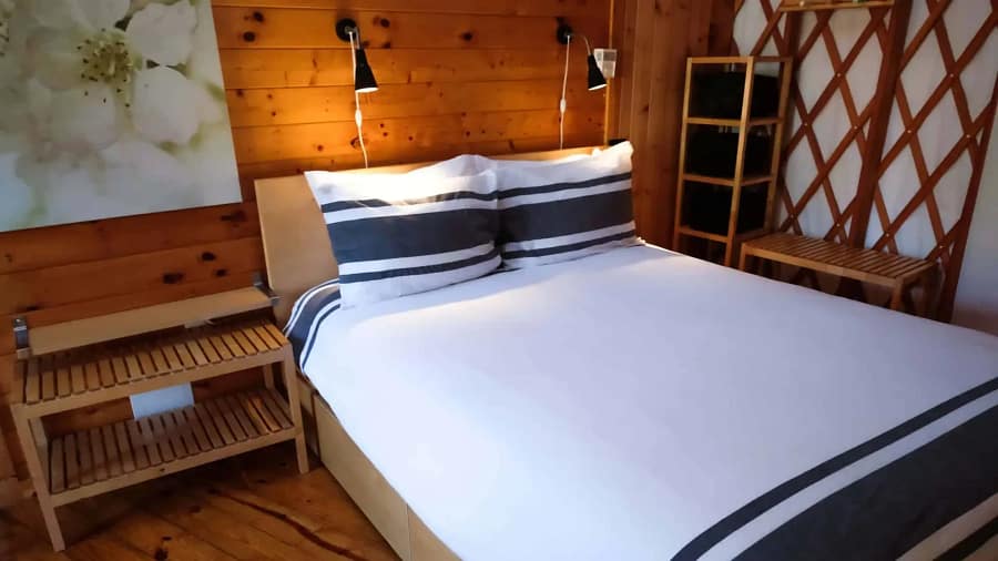 A bed or beds in a room with wooden walls.
